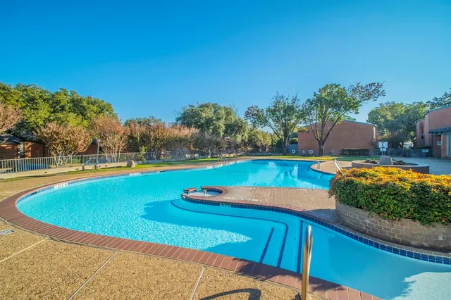 a view of a swimming pool with an outdoor space and seating area