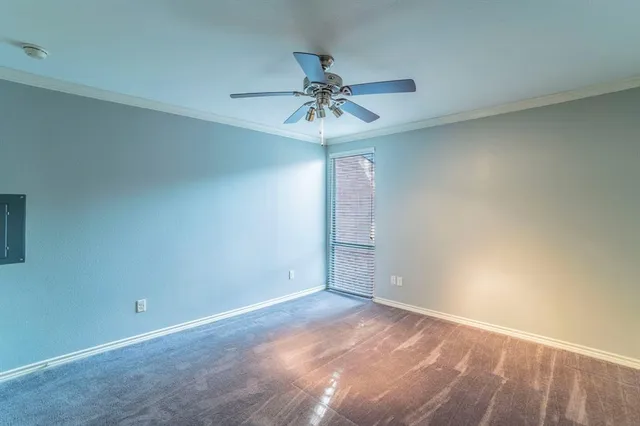 an empty room and chandelier fan