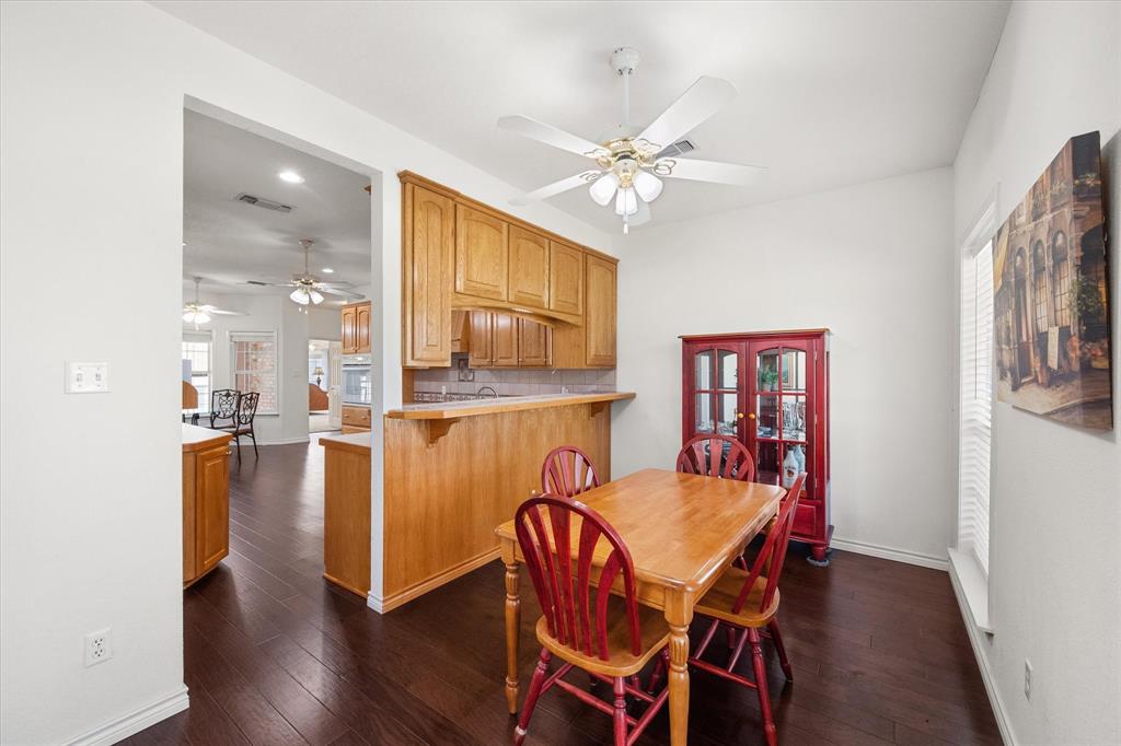 13021 Rudy's Way Streetman, TX 75859 - Photo 3 of 40 Dining area near Dallas with warm wood flooring, kitchen pass-through, and bright windows for everyday lake-area living.