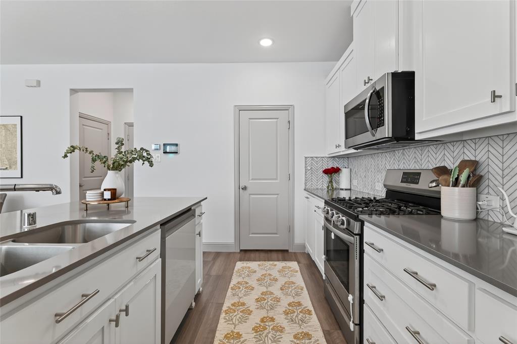9000 Phoebe Road Frisco, TX 75035 - Photo 14 of 27 a kitchen with stainless steel appliances granite countertop a sink stove and refrigerator