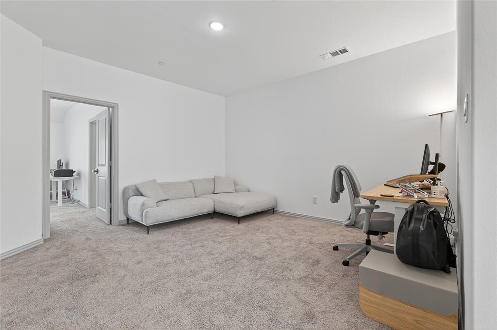 9000 Phoebe Road Frisco, TX 75035 - Photo 19 of 27 a living room with furniture and a gym cycle