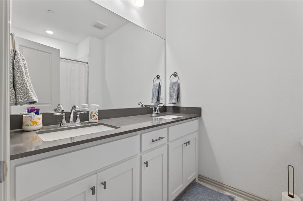 9000 Phoebe Road Frisco, TX 75035 - Photo 24 of 27 a bathroom with a double vanity sink and a mirror