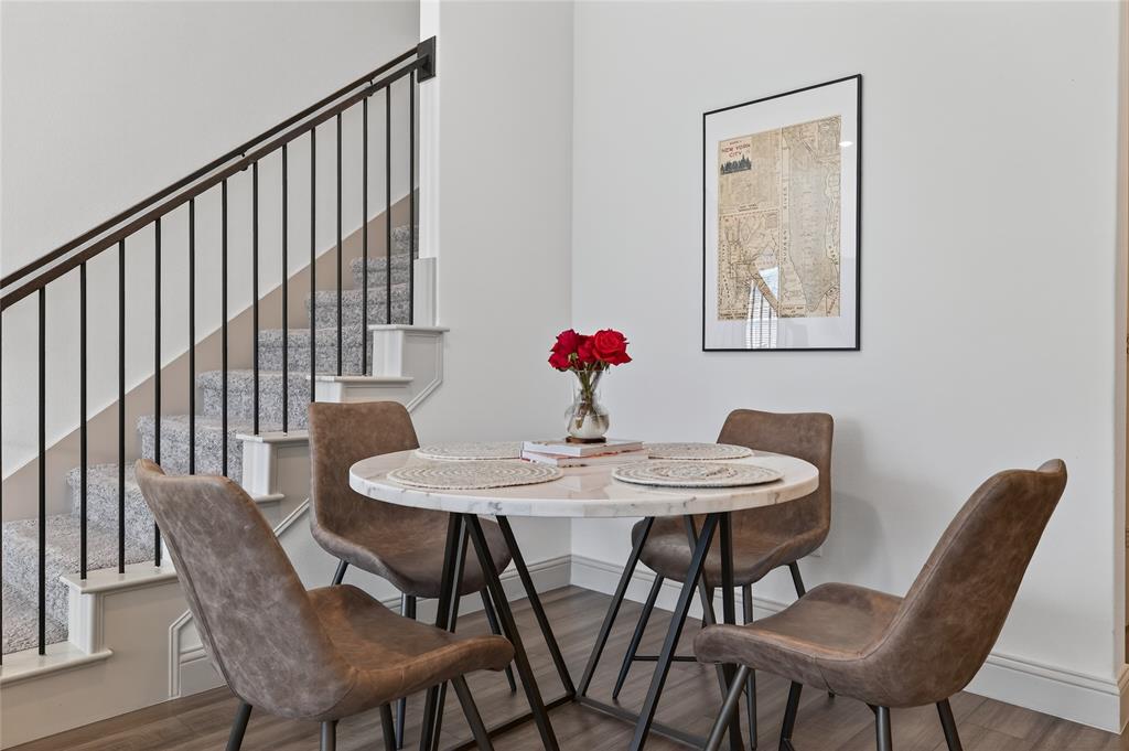 9000 Phoebe Road Frisco, TX 75035 - Photo 10 of 27 a view of a dining room with furniture and wooden floor