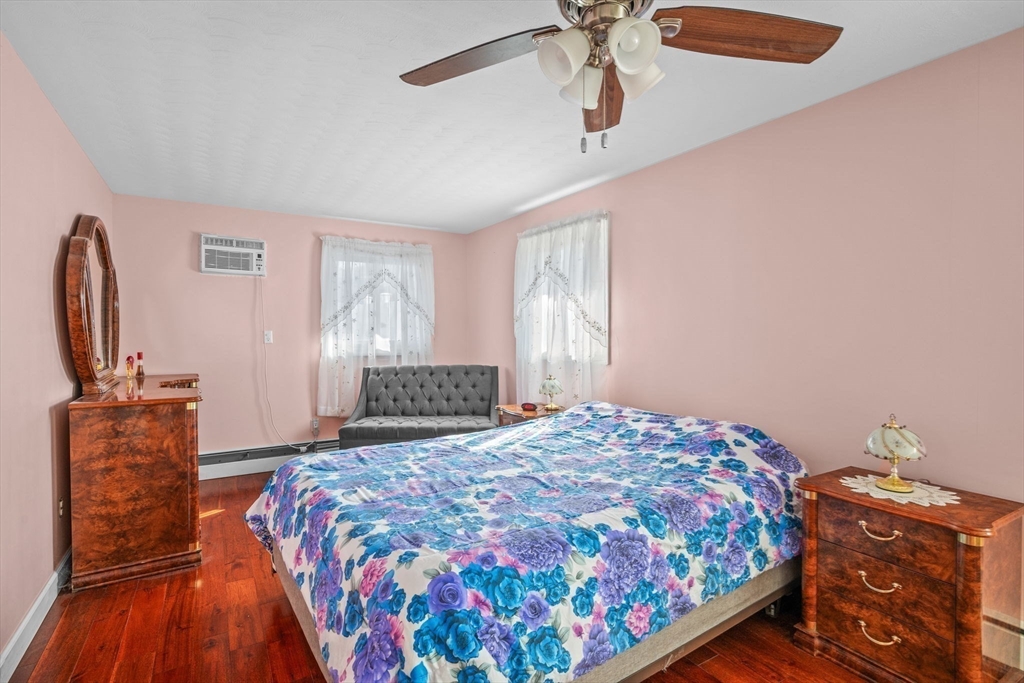 1 Reed Road Peabody, MA 01960 - Photo 18 of 31 a bedroom with a bed and wooden floor