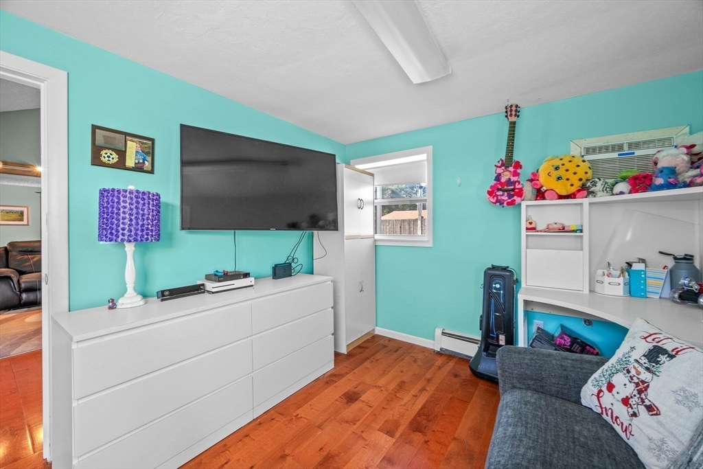 1 Reed Road Peabody, MA 01960 - Photo 25 of 31 a bedroom with a bed and a flat screen tv