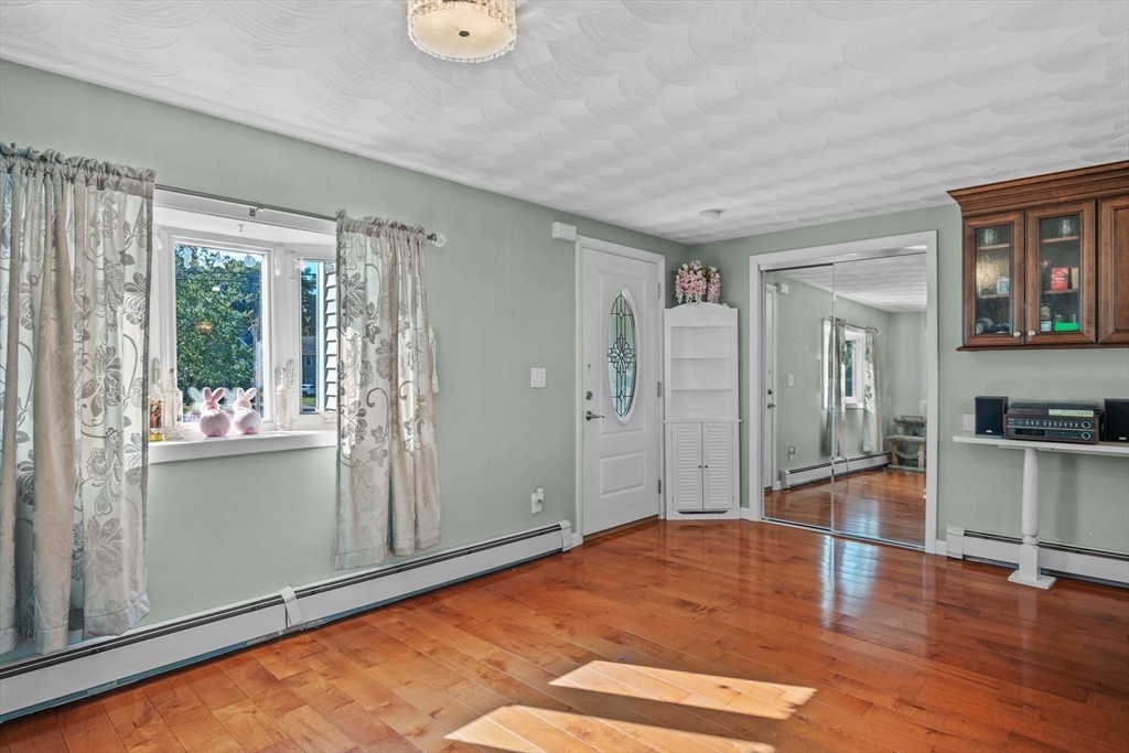 1 Reed Road Peabody, MA 01960 - Photo 4 of 31 a view of a livingroom with wooden floor and kitchen space with a sink