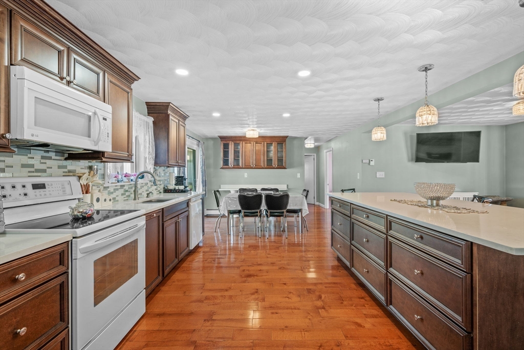 1 Reed Road Peabody, MA 01960 - Photo 8 of 31 a large kitchen with stainless steel appliances granite countertop a large counter top a sink and a stove