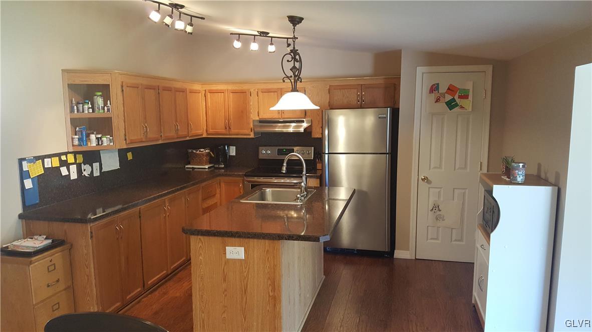 975 Bushkill Center Road Nazareth, PA 18064 - Photo 21 of 48 a kitchen with stainless steel appliances granite countertop a refrigerator a sink a stove and island