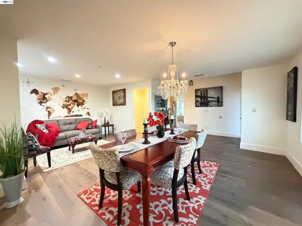 a view of a dining room with furniture and chandelier