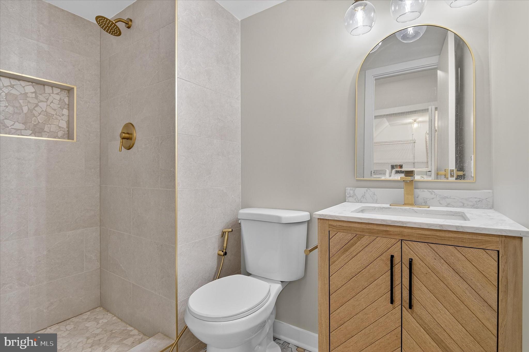10502 Oronoco Lane Manassas, VA 20109 - Photo 11 of 37 a bathroom with a toilet sink vanity and mirror