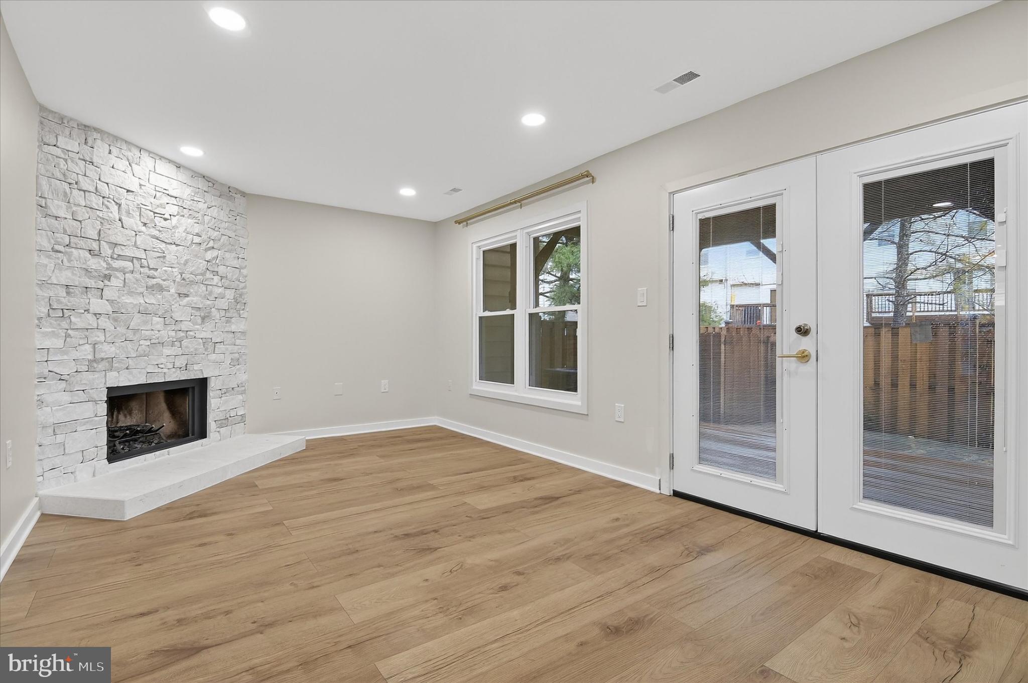 10502 Oronoco Lane Manassas, VA 20109 - Photo 12 of 37 a view of an empty room with a fireplace and a window