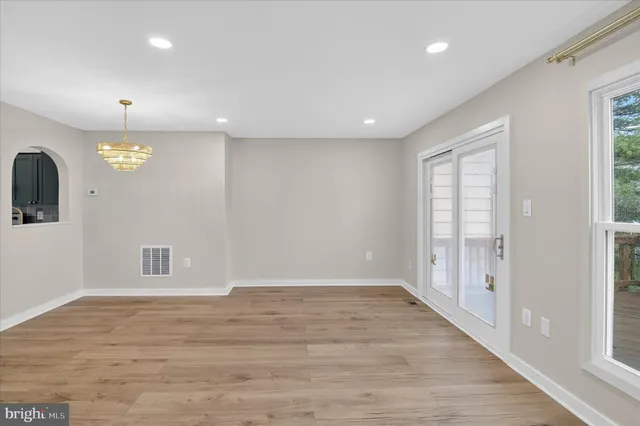 a view of a room with wooden floor
