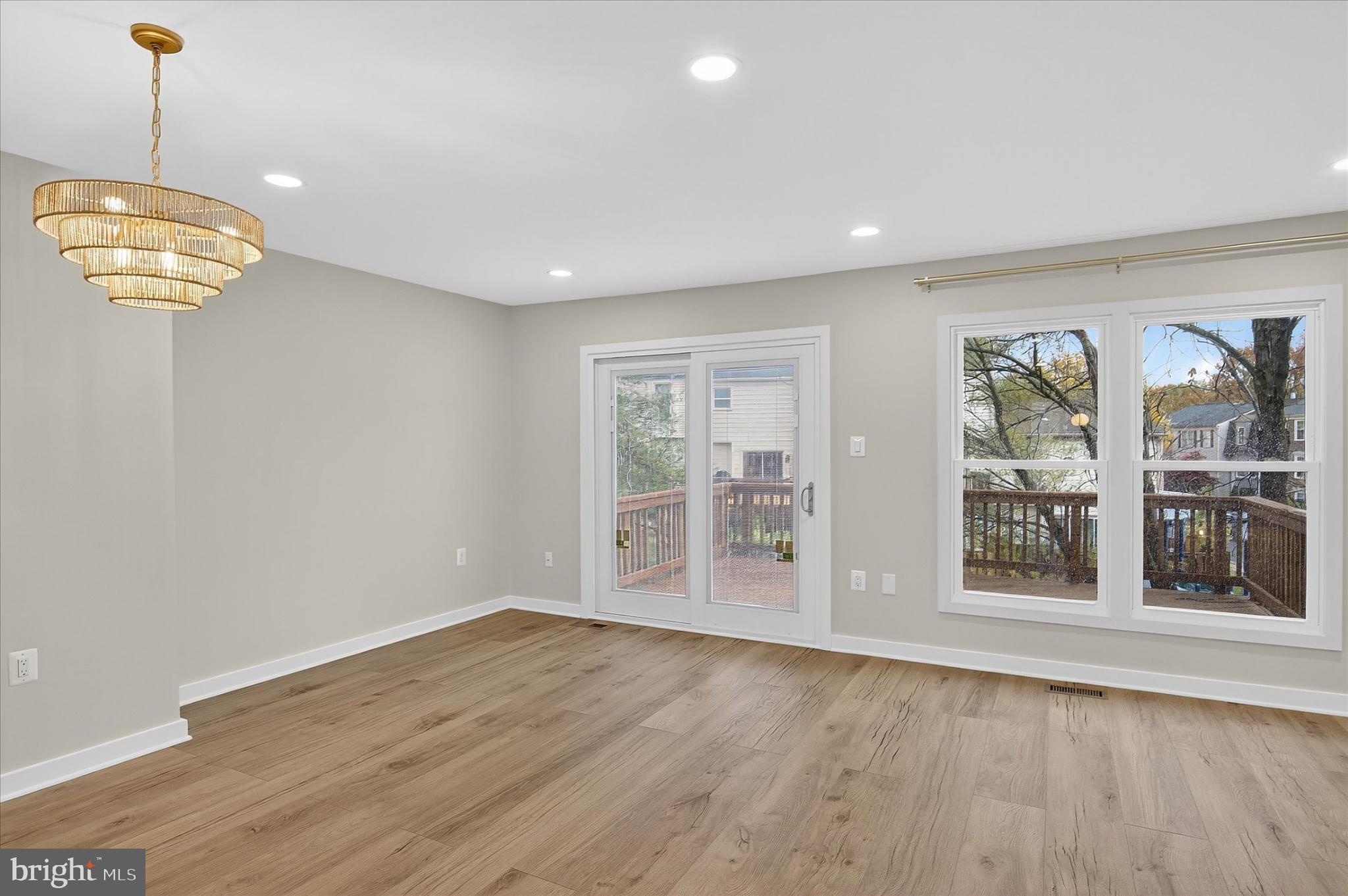 10502 Oronoco Lane Manassas, VA 20109 - Photo 17 of 37 a view of an empty room with wooden floor and a window