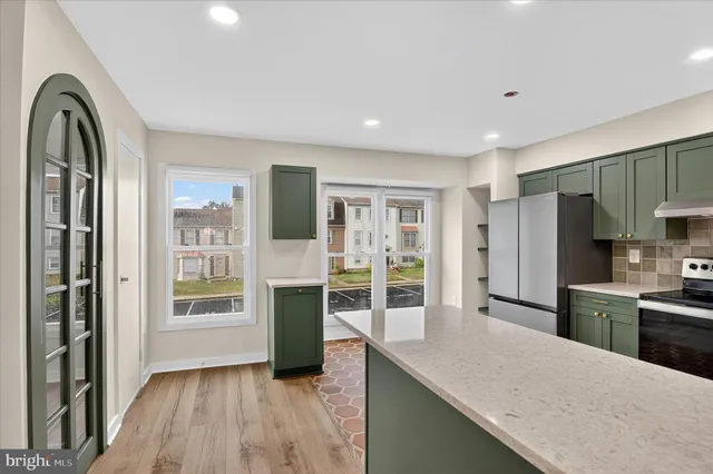 a kitchen with granite countertop a refrigerator and a sink