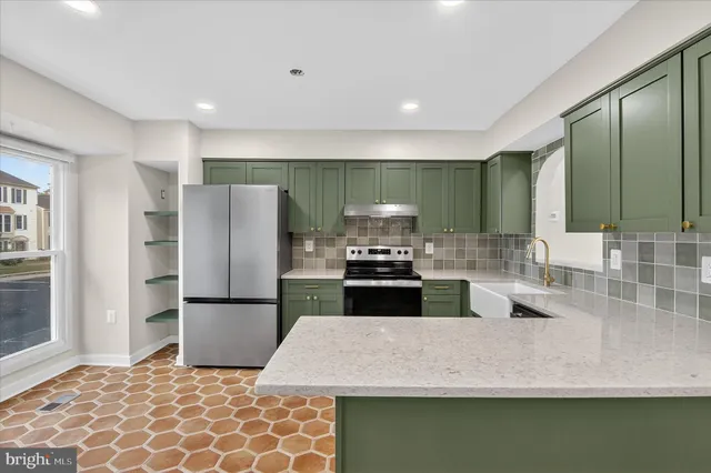 a kitchen with granite countertop a sink and stainless steel appliances