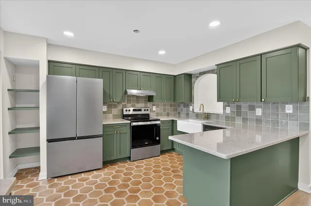 a kitchen with granite countertop a sink a counter top space appliances and cabinets