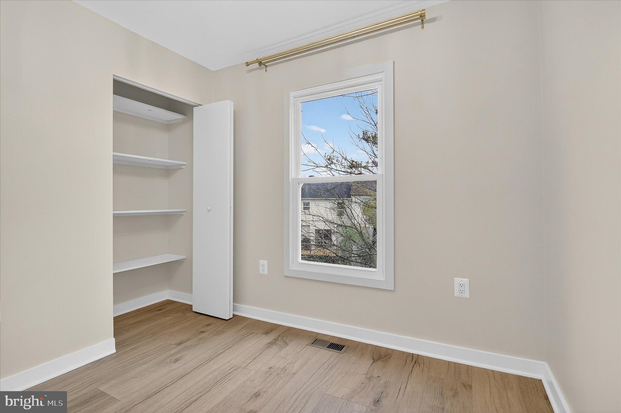 10502 Oronoco Lane Manassas, VA 20109 - Photo 27 of 37 a view of an empty room with wooden floor and a window