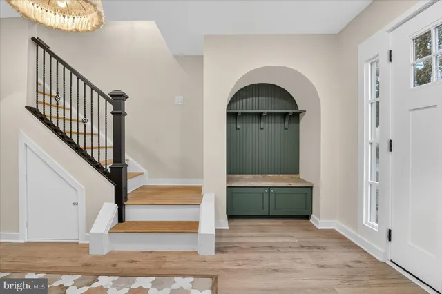 a view of entryway with wooden floor and stairs