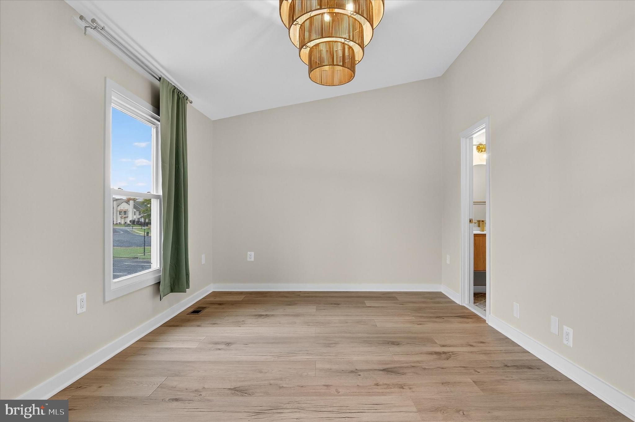 10502 Oronoco Lane Manassas, VA 20109 - Photo 32 of 37 an empty room with wooden floor and windows