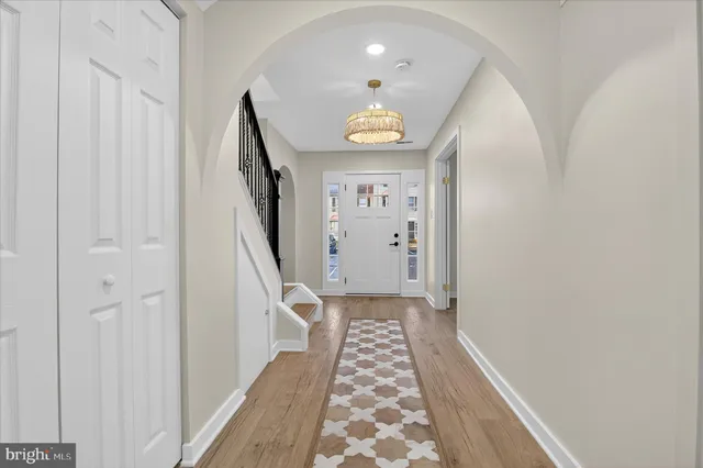 a view of a hallway with wooden floor and staircase