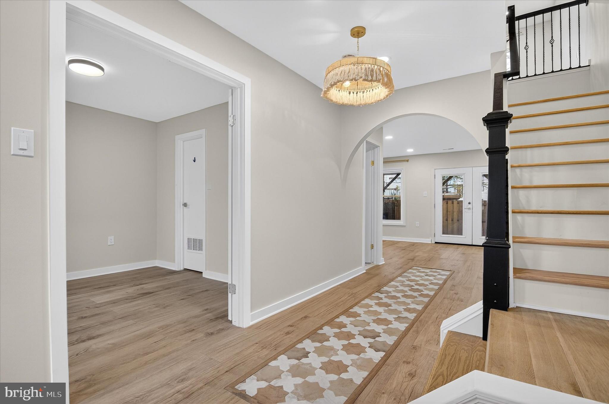 10502 Oronoco Lane Manassas, VA 20109 - Photo 7 of 37 a view of a hallway with wooden floor and staircase