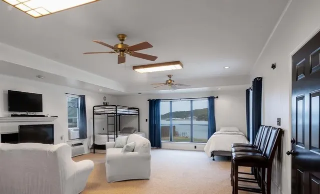 a living room with furniture a flat screen tv and a large window