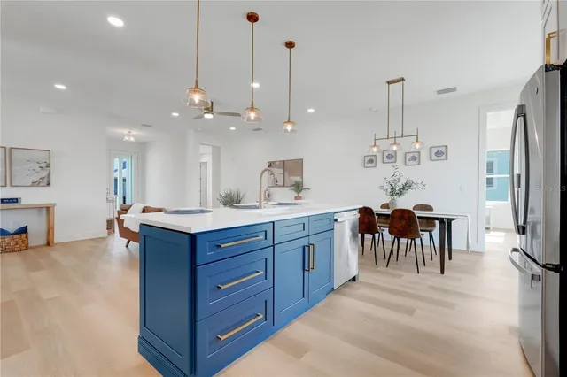 a kitchen with kitchen island a counter top space appliances and a center island