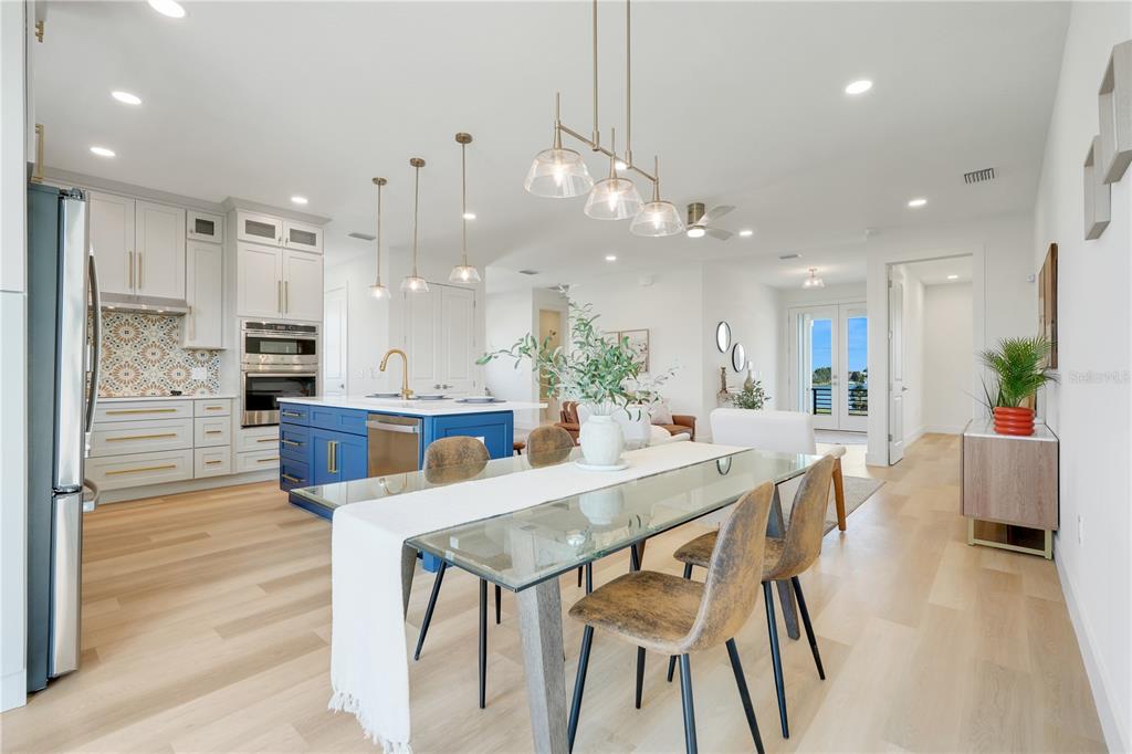 3496 Amberjack Drive Hernando Beach, FL 34607 - Photo 13 of 52 a view of a dining room and livingroom with furniture wooden floor a chandelier