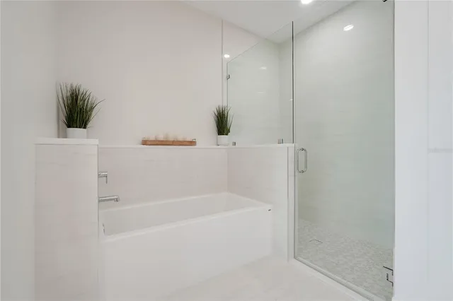 a white bath tub sitting next to a shower