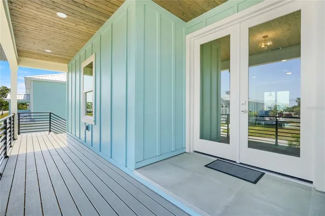 a view of outdoor space with wooden floor and windows