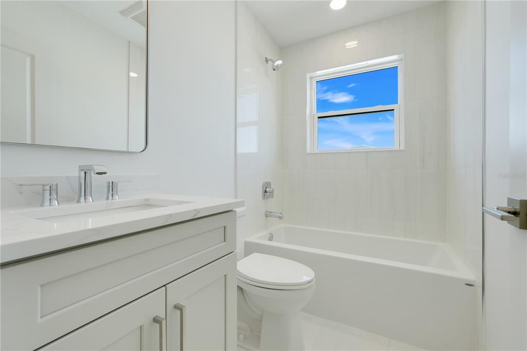 3496 Amberjack Drive Hernando Beach, FL 34607 - Photo 32 of 52 a bathroom with a granite countertop sink a toilet and shower
