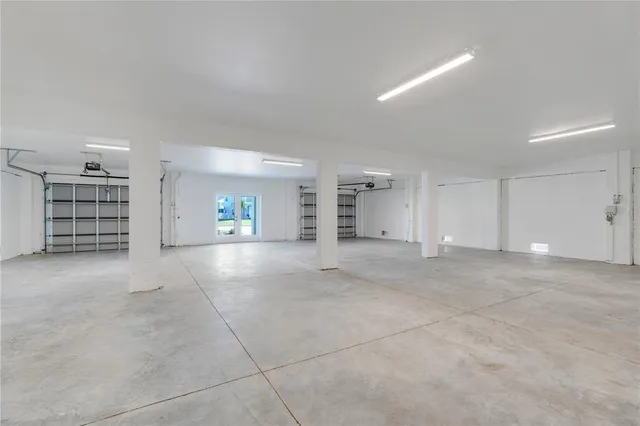 an aerial view of a house with a garden and lake view