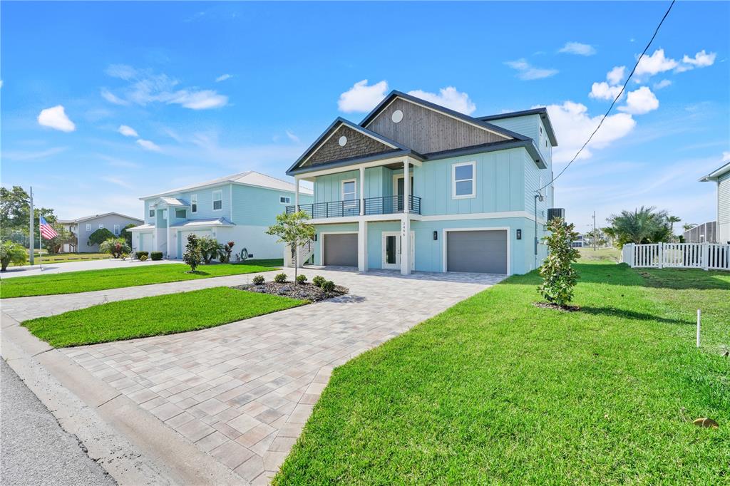 3496 Amberjack Drive Hernando Beach, FL 34607 - Photo 45 of 52 a front view of a house with a yard and garage
