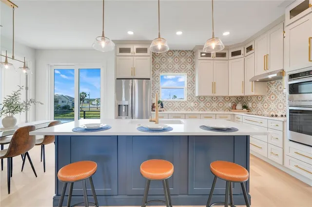 a kitchen with furniture a counter space a sink and a window