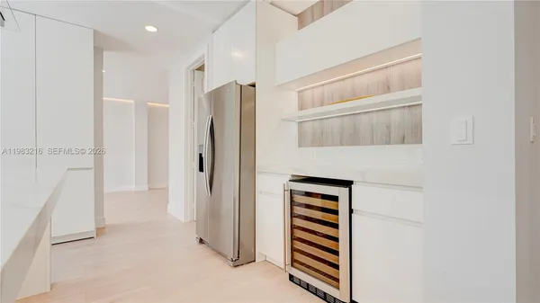 a view of a living room a kitchen and a wooden floor