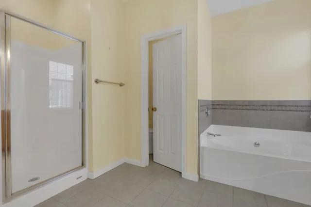 a bathroom with a tub and shower