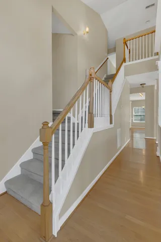 a view of staircase with white walls and a next to a window
