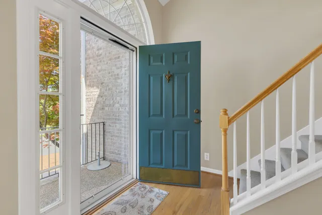 a view of entryway with wooden floor and stairs