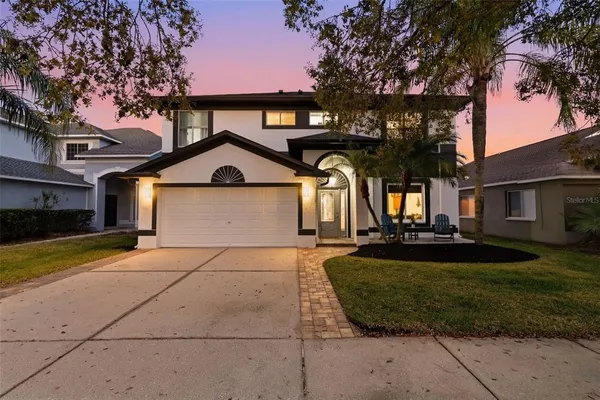 a front view of a house with a yard and garage