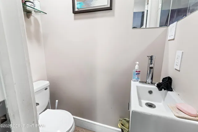a white toilet sitting next to a bathroom sink