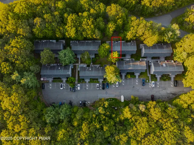 an aerial view of a house with yard basket ball court and outdoor seating