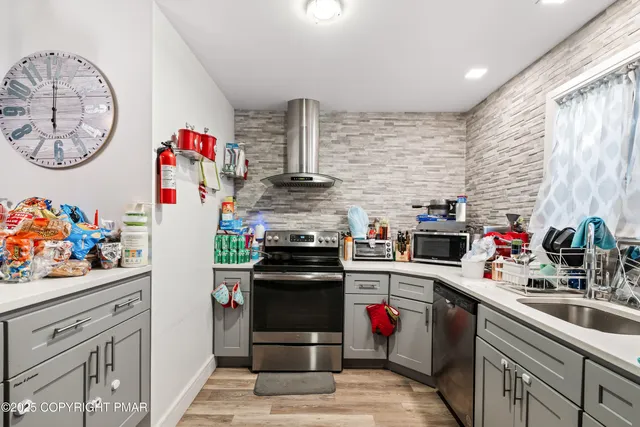 a kitchen with refrigerator and a stove