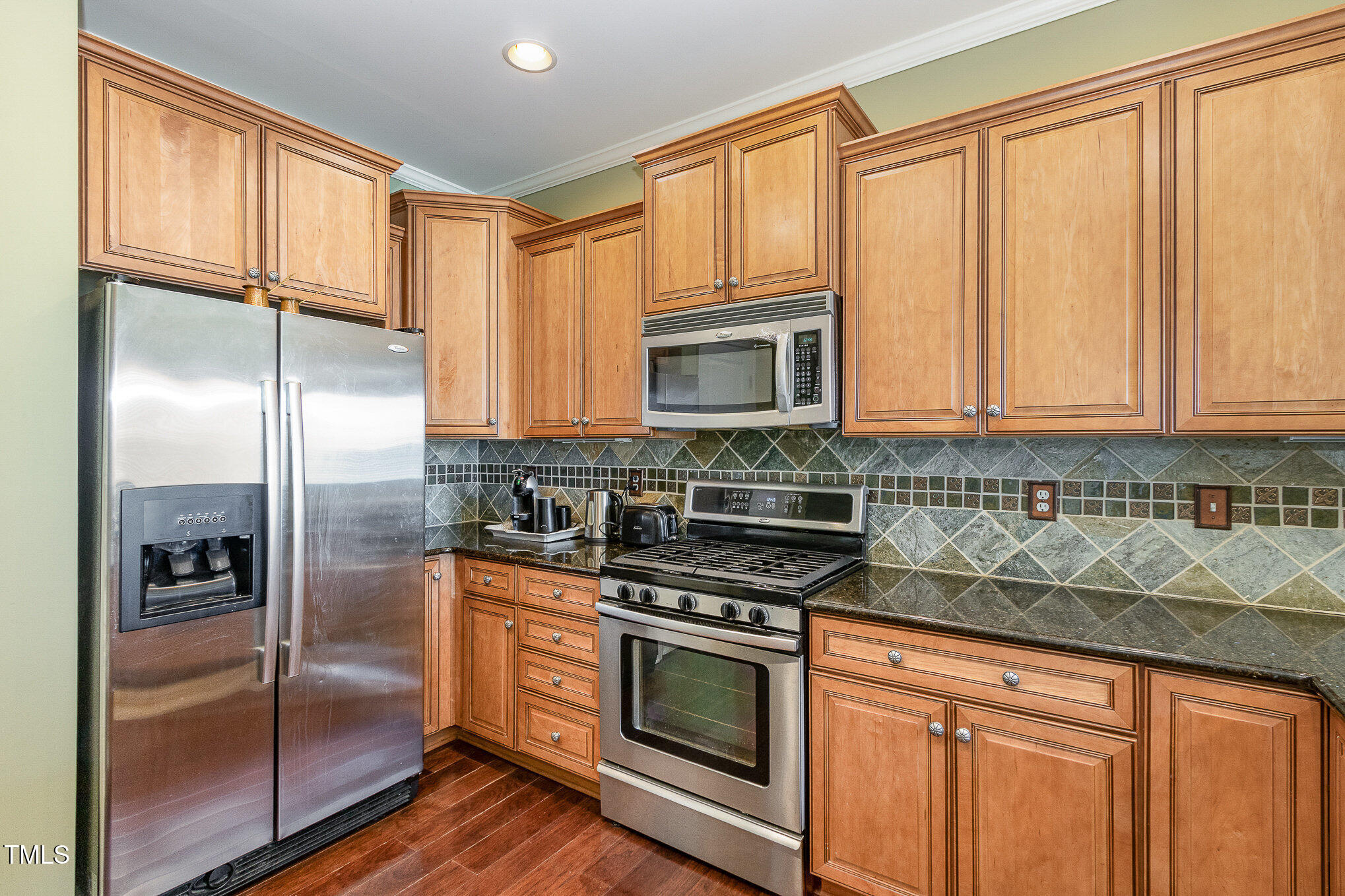 9207 Wooden Road Raleigh, NC 27617 - Photo 9 of 27 a kitchen with stainless steel appliances granite countertop a refrigerator a stove a sink and dishwasher with wooden floor