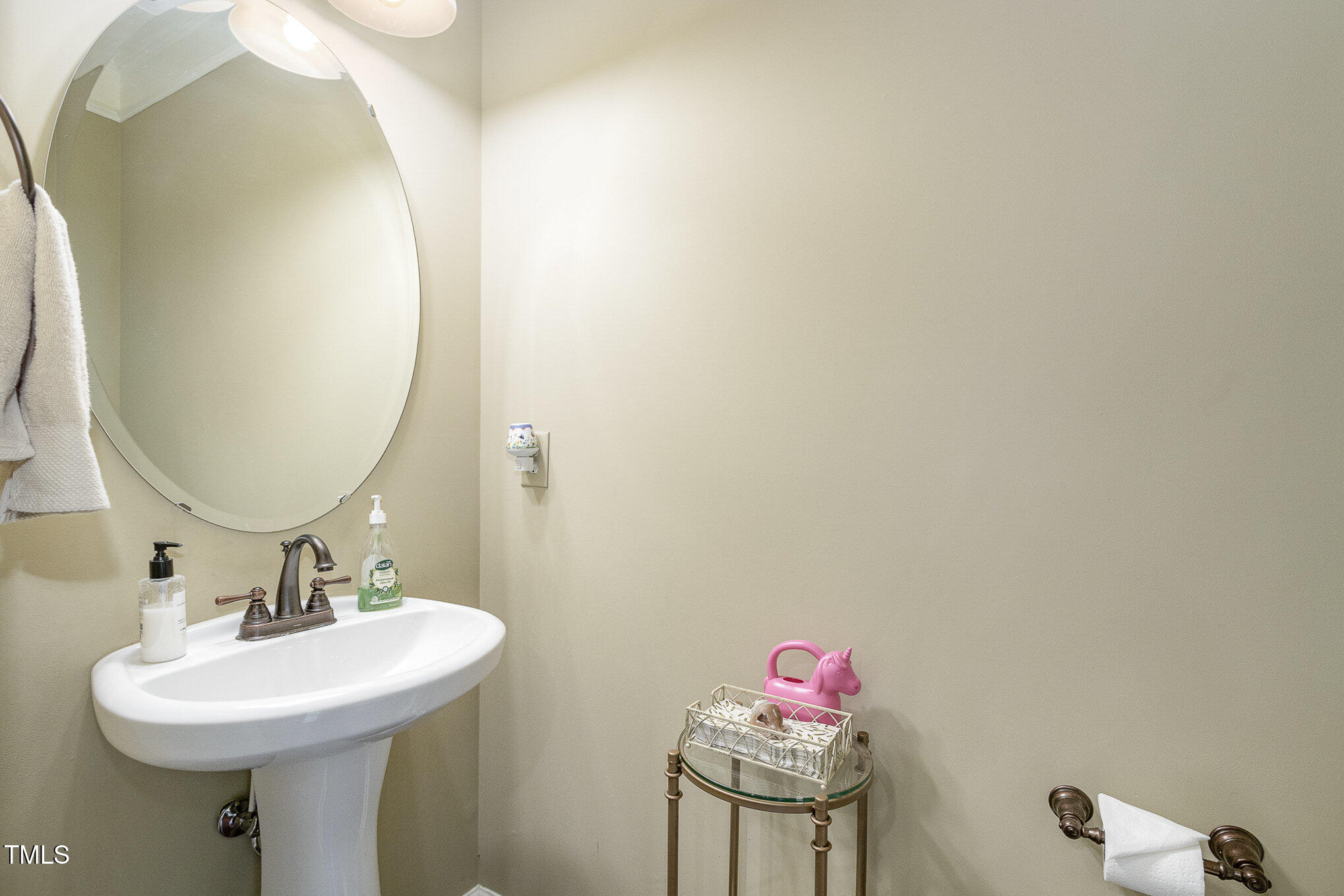 9207 Wooden Road Raleigh, NC 27617 - Photo 11 of 27 a bathroom with a sink and a mirror