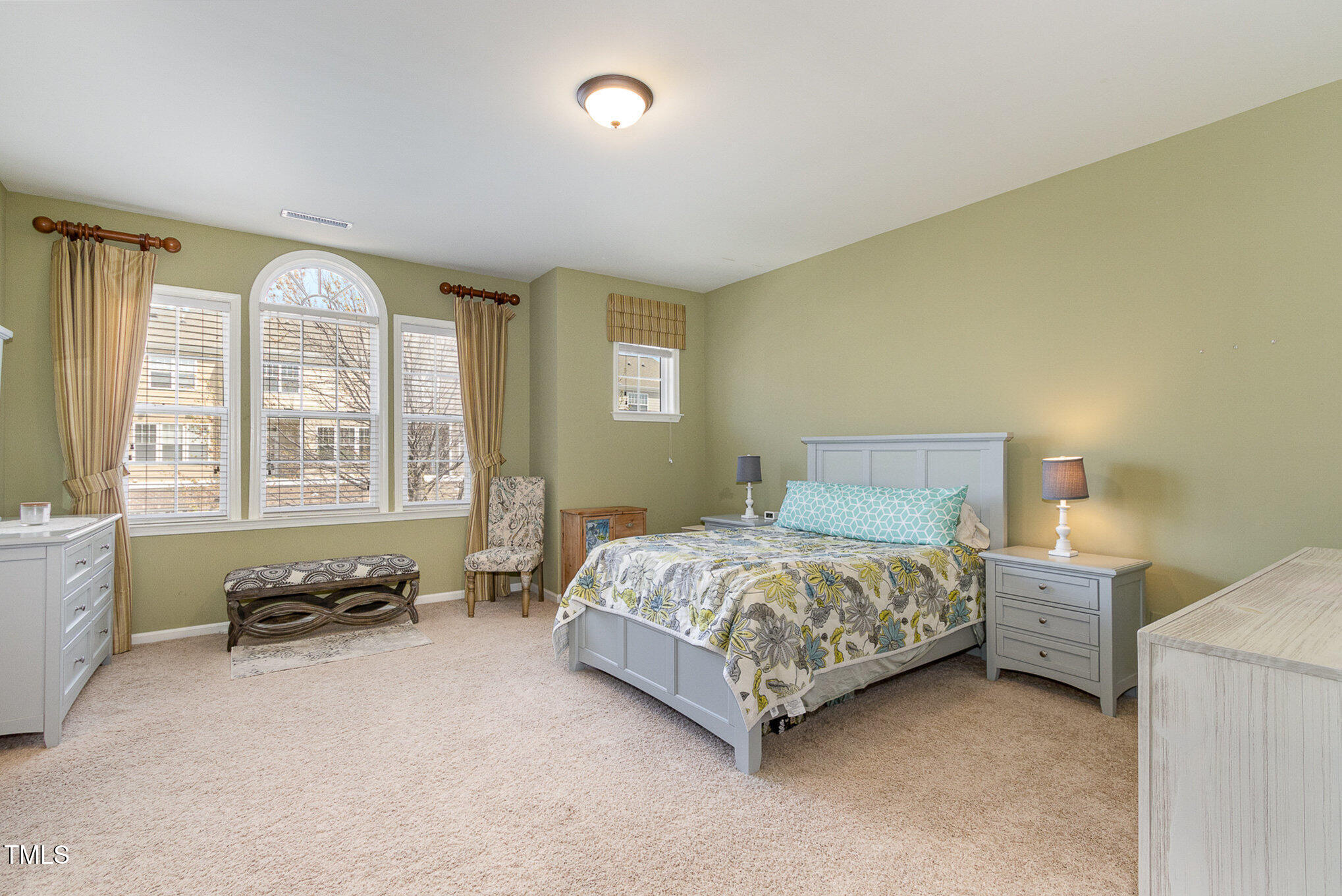 9207 Wooden Road Raleigh, NC 27617 - Photo 18 of 27 a spacious bedroom with a bed and a large window