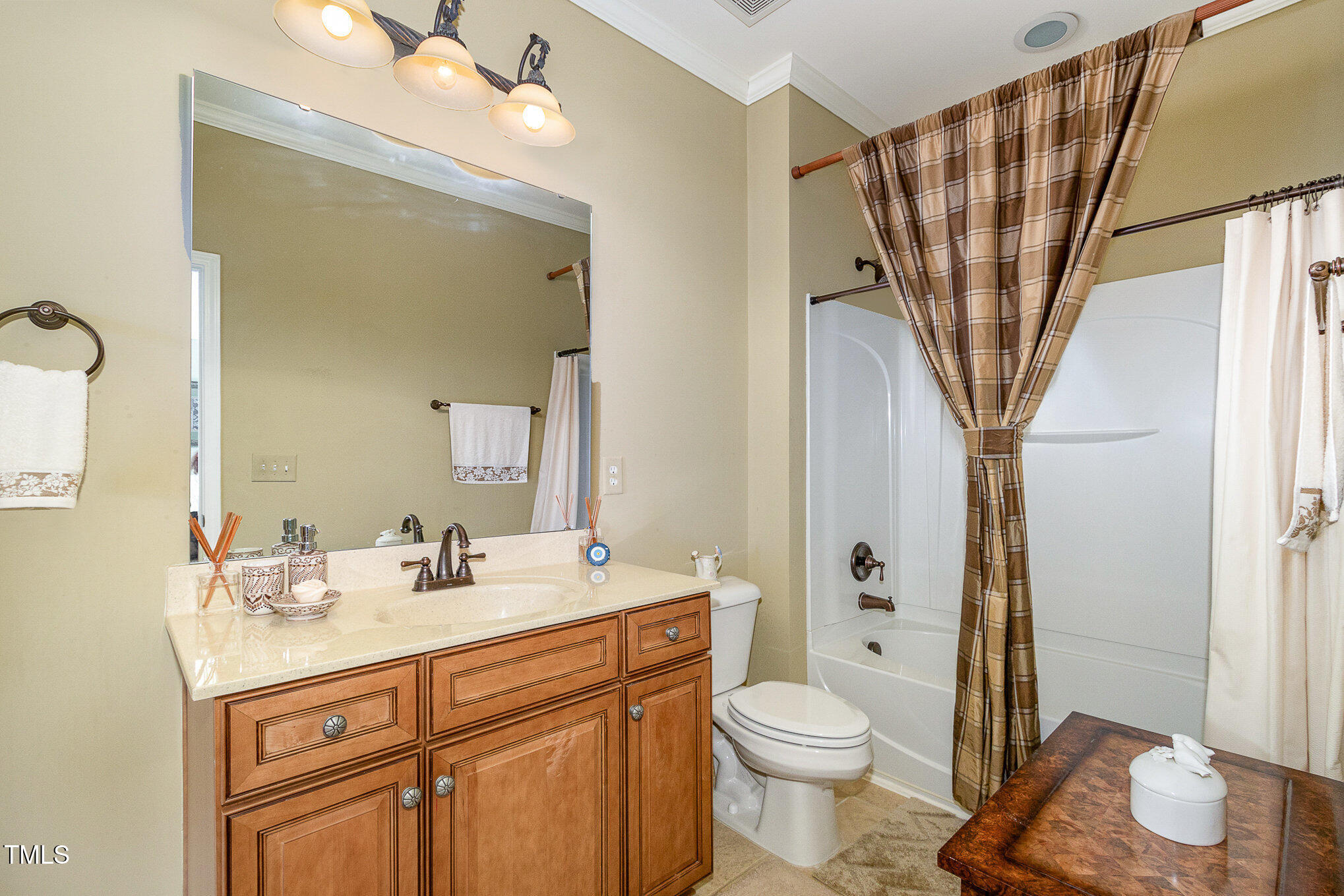 9207 Wooden Road Raleigh, NC 27617 - Photo 23 of 27 a bathroom with a sink a toilet and shower