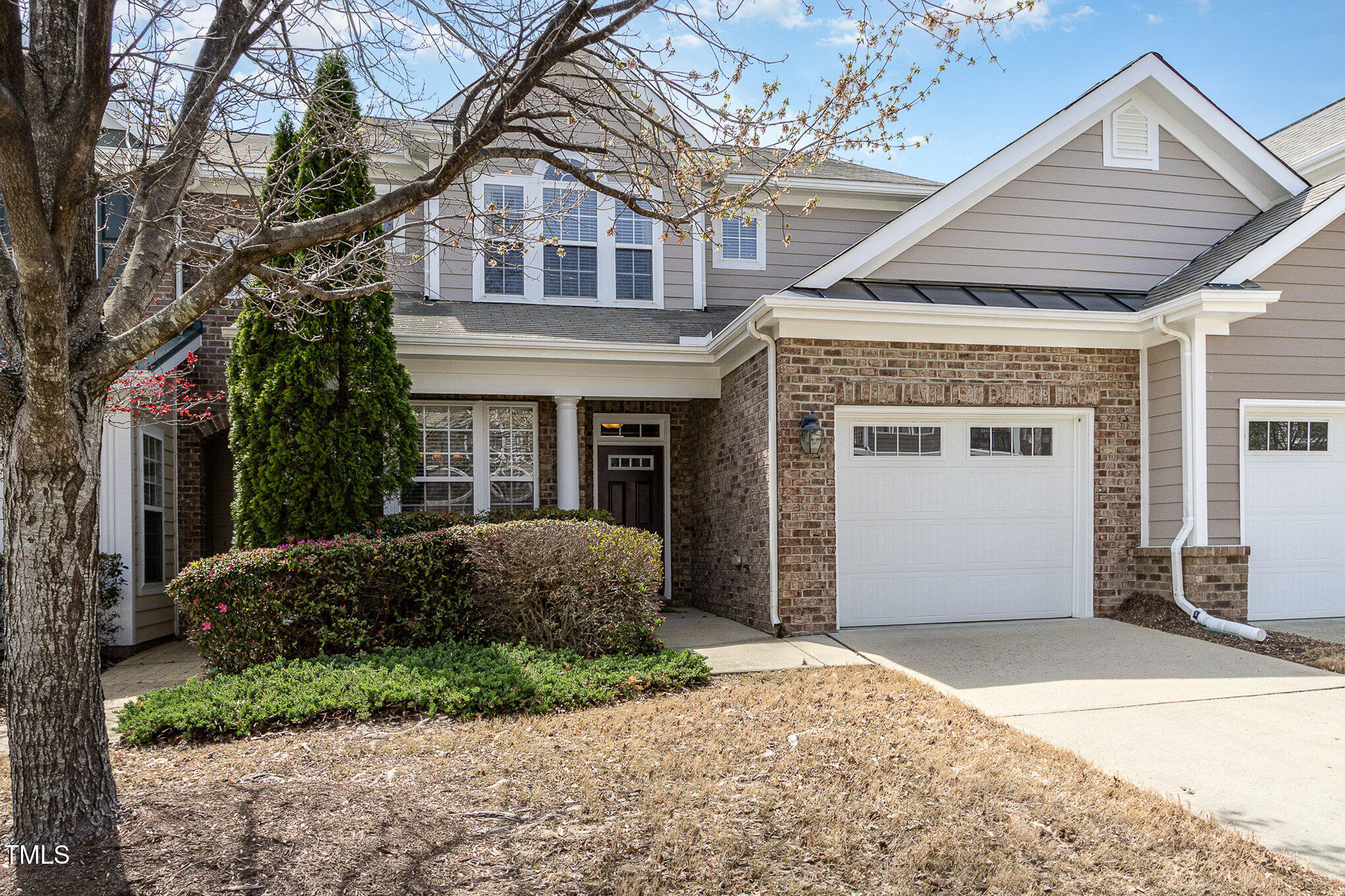 9207 Wooden Road Raleigh, NC 27617 - Photo 3 of 27 a front view of a house with a garden