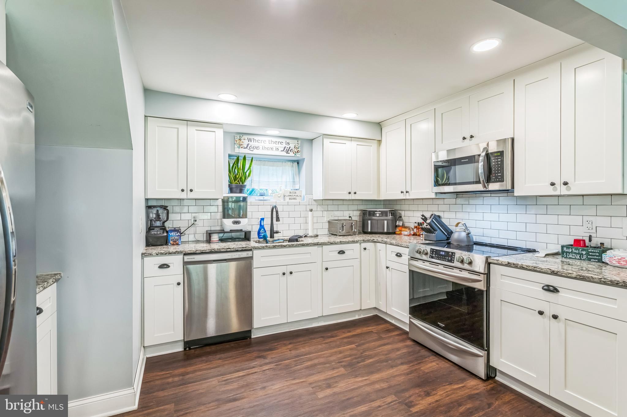 414 Delaware Avenue Croydon, PA 19021 - Photo 14 of 34 a kitchen with granite countertop white cabinets and white appliances
