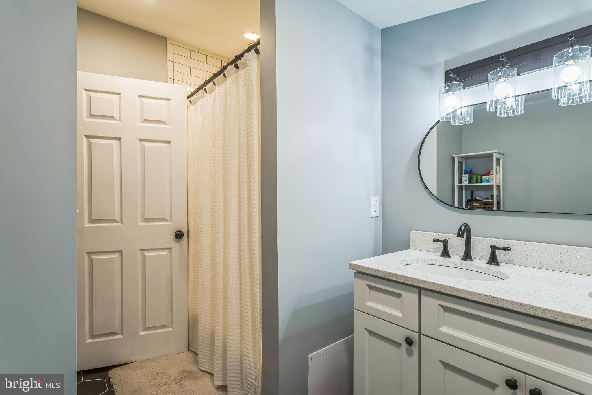 414 Delaware Avenue Croydon, PA 19021 - Photo 24 of 34 a bathroom with a sink and a mirror