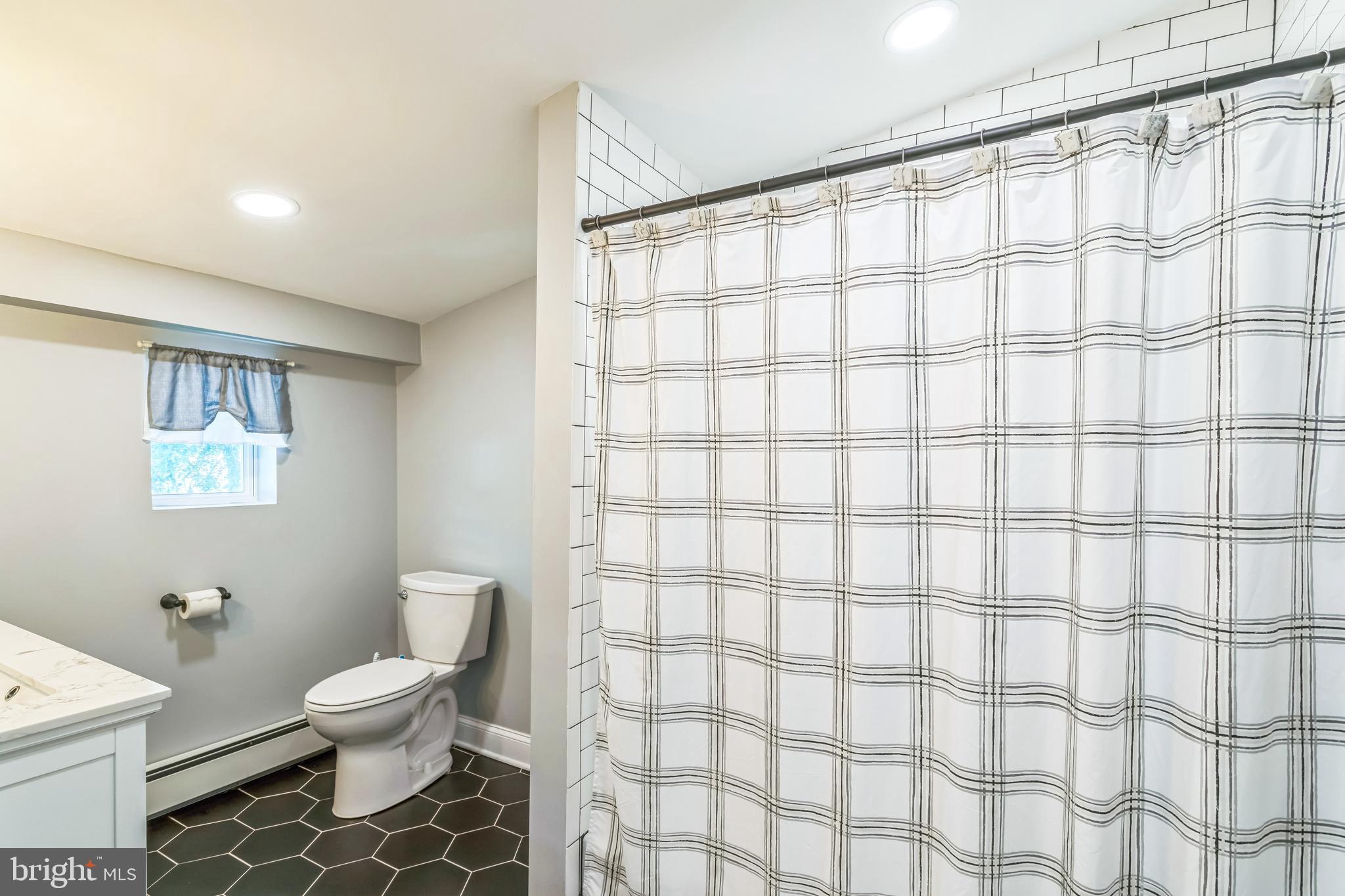 414 Delaware Avenue Croydon, PA 19021 - Photo 28 of 34 a white toilet sitting next to a bathroom sink